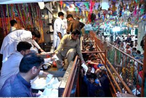 People standing in queue to get free milk as a large number of people arrives to attend the three day 981st urs celebration of renowned Sufi Data Gunj Buksh.