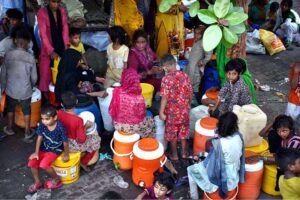 People standing in queue to get free milk as a large number of people arrives to attend the three day 981st urs celebration of renowned Sufi Data Gunj Buksh.