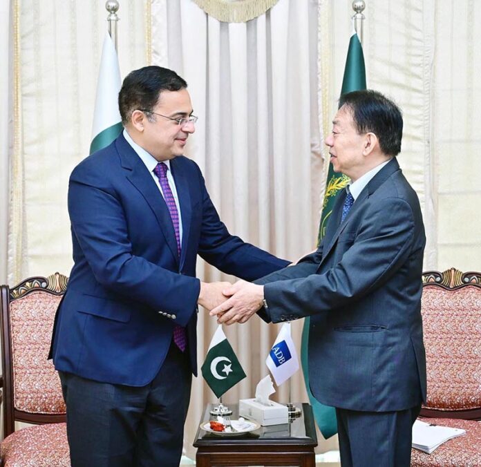 Federal Minister for Economic Affairs Ahad Cheema is shaking hand with Masatsugu Asakawa President of Asian Development Bank in Federal Capital