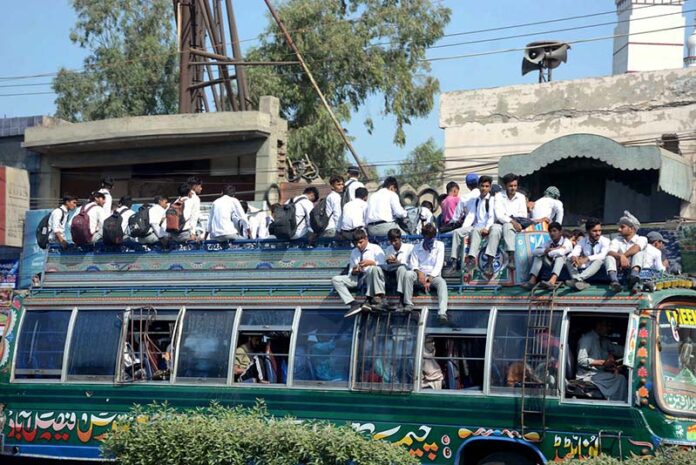 A large number of students traveling in a dangerous way on rooftop of passenger bus may cause any mishap and needs the attention of concerned authorities