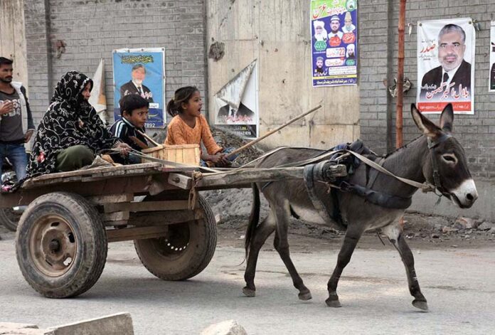 Gypsy family traveling on a donkey cart heading towards their destination