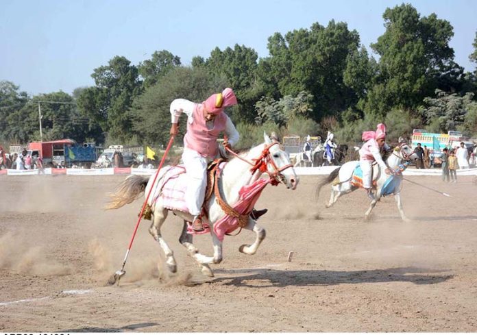 Horse riders participating in Tent Pegging Championship in Sports ...