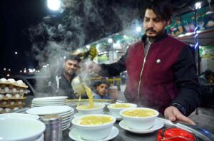 A vendor sells hot and sour chicken corn soup to attract customers during the winter season at Haji Camp Road in the city.