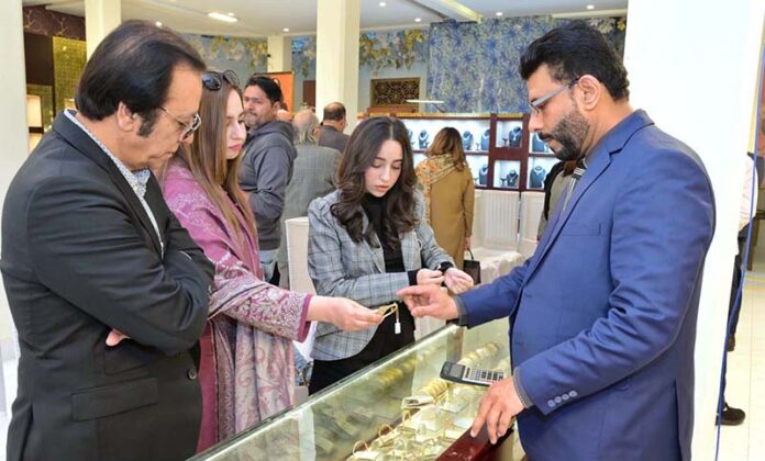 A family viewing jewelry at the Damas Jewelry Exhibition, at (SOM), Living Dreams Marquee, Sialkot Cantt