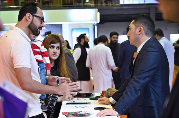 Visitors taking interest in stalls during the Pakistan Travel Mart (PTM) 2025 at Expo Centre