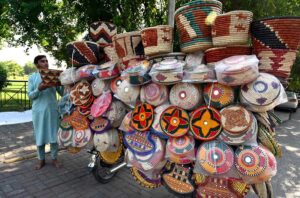 A vendor displaying and selling household items to attract customers in the Federal Capital.