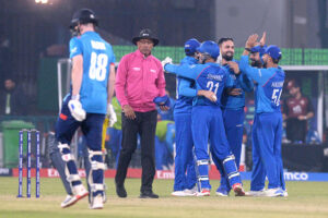 Afghanistan players celebrate after winning the crucial ICC Champions Trophy one-day international (ODI) cricket match against England at the Gaddafi Stadium.