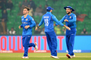 Afghanistan players celebrate after winning the crucial ICC Champions Trophy one-day international (ODI) cricket match against England at the Gaddafi Stadium.