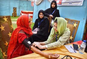 A doctor examining a patient during free eye camp organized by host lions club at Police ground.