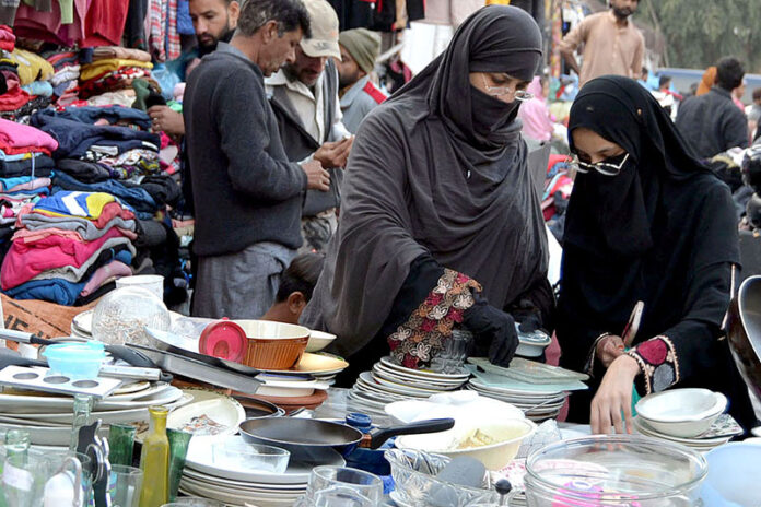 Ladies selecting and purchasing the household utensils to the roadside vendor near the Mayo Hospital