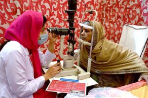 A doctor examining a patient during free eye camp organized by host lions club at Police ground.