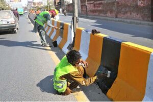 PHA staffers are busy in painting the cemented dividers at center of LMQ Road