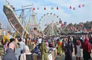 Students selecting key chain at a stall during Gur Mela of 10th Lyallpur Arts & Literature Festival at University of Agriculture Faisalabad (UAF).