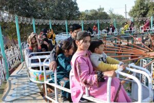 Students selecting key chain at a stall during Gur Mela of 10th Lyallpur Arts & Literature Festival at University of Agriculture Faisalabad (UAF).