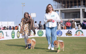 Pet lovers along with their pet dogs participating in a Dog show organized by Multan Kennel Union at DHA.