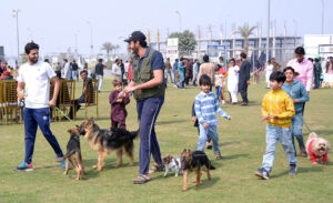 Pet lovers along with their pet dogs participating in a Dog show organized by Multan Kennel Union at DHA.