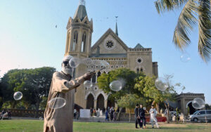 An old man selling water bubbles at the historic Frere Hall.