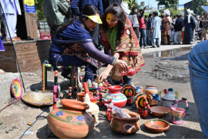 Women displaying Punjabi cultural itmes On International Mother Language Day, at Shimla Hill Chowk.