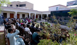 People watching the ODI Champion Trophy cricket match between Pakistan and India on big TV screen at Sindh Sports Complex.