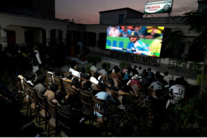 People watching the ODI Champion Trophy cricket match between Pakistan and India on big TV screen at Sindh Sports Complex.