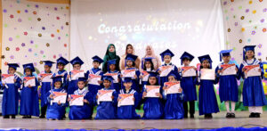 Junior graduates in a group photo with the officials at the Graduation Ceremony 2025 of Islamabad Grammar Schools at Shah Abdul Latif Bhitai Auditorium