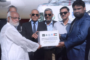 Vice President Al Khidmat Foundation Air Vice Marshall (Retd) Arshad Malik presenting relief goods for Palestinians to Manager Logistics National Disaster Management Authority ( NDMA) Ali Zarik at old terminal of Karachi Airport