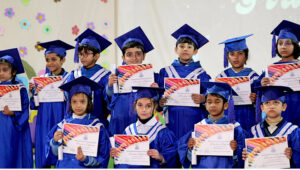 Junior graduates in a group photo with the officials at the Graduation Ceremony 2025 of Islamabad Grammar Schools at Shah Abdul Latif Bhitai Auditorium