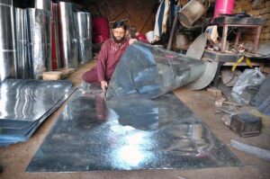 A blacksmith is busy at work in his workshop in the Lahori area, skillfully shaping metal with precision.