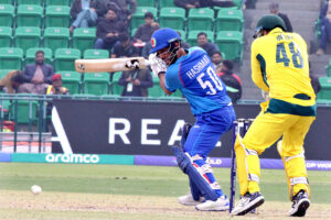 Afghanistan batter Azmat Ullah plays a shot during the ICC Champions Trophy (ODI) cricket match between Afghanistan and Australia at the Gaddafi Stadium.