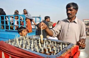 A vendor selling traditional Kulfi sweet at his roadside stall.