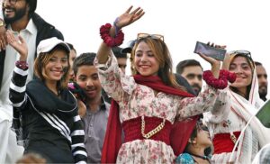 Enthusiastic female cricket fans cheer and waving their hands in excitement during the ICC Champions Trophy match between Bangladesh and New Zealand at Rawalpindi Cricket Stadium