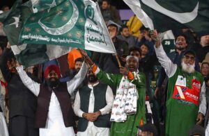 An excited cricket fan holds a Jhunjhuna rattle and plays it with both hands during the ICC Champions Trophy match between Bangladesh and New Zealand at Rawalpindi Cricket Stadium