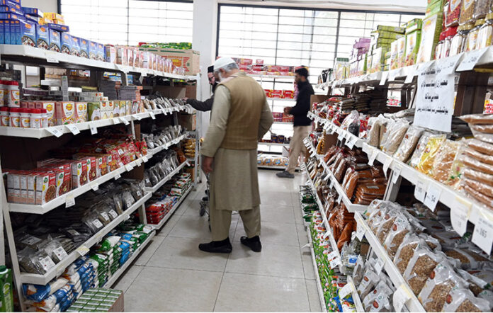 People purchasing grocery items from store at G-7 market