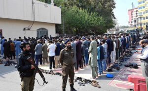 People offer Friday prayer on the first friday of Ramadan ul mubarak while security personnels stand alert at Shimla Pahari Chowk.