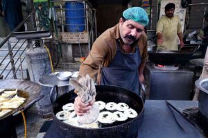 Vendor preparing traditional sweet item (Jalebi) for iftar during holy fasting month of Ramadan near Ghouri VIP in the Federal Capital