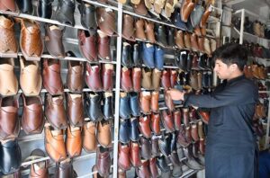 A vendor displaying and selling traditional Peshawari Chappal to attract customers at G-9 in the Federal Capital.