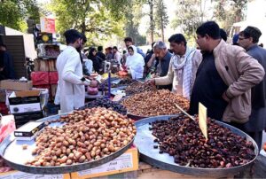 People purchasing dates for iftar at Sasta Ramadan bazaar Aabpara in the Federal Capital