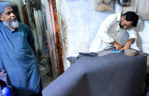 Artisan is busy sewing leather before preparing sandals for sale at a local sandal factory in Fort Area, in connection with the upcoming Eid-ul-Fitr.