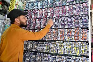 A person purchasing shoes from a shop in Aabpara Market as people shopping for preparation of upcoming Eidul Fitr