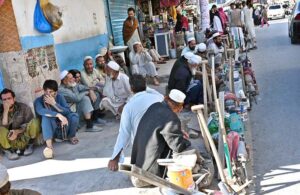 A large number of laborers, along with their tools, are waiting to be hired while sitting at Banni Chowk.