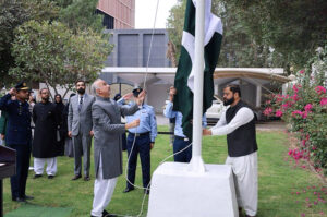 Ambassador Faisal Niaz Tirmizi hoisting flag during a ceremony to commemorate Pakistan's National Day at the Embassy.