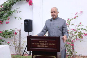 Ambassador Faisal Niaz Tirmizi hoisting flag during a ceremony to commemorate Pakistan's National Day at the Embassy.