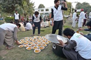 Workers of Life Care Foundation distributing free food for iftar at Queen Chowk during the holy fasting month of Ramzan ul Mubarak.