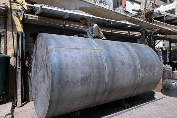 A worker busy welding and repairing petrol tank at fort road