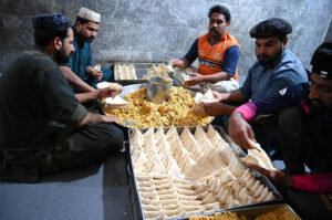 Workers busy in preparing traditional food item samosas before frying at their workplace during the Holy Month of Ramadan-ul-Mubarak