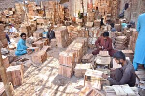 Workers are busy making wooden boxes at their workplace.