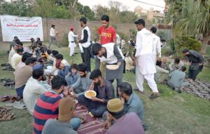 Workers of Life Care Foundation distributing free food for iftar at Queen Chowk during the holy fasting month of Ramzan ul Mubarak.