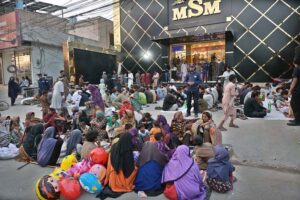 Volunteers distributing free food for iftari in front of MSM Shopping Mall at College Road.