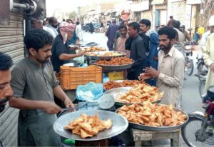 A worker preparing traditional sweet item Amriti use for iftar at Hyder chowk