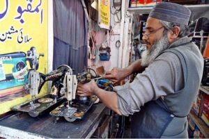 A worker busy in embroidery work on clothes at his workplace for customers as people starts preparation for the upcoming Eidul Fitr celebrations